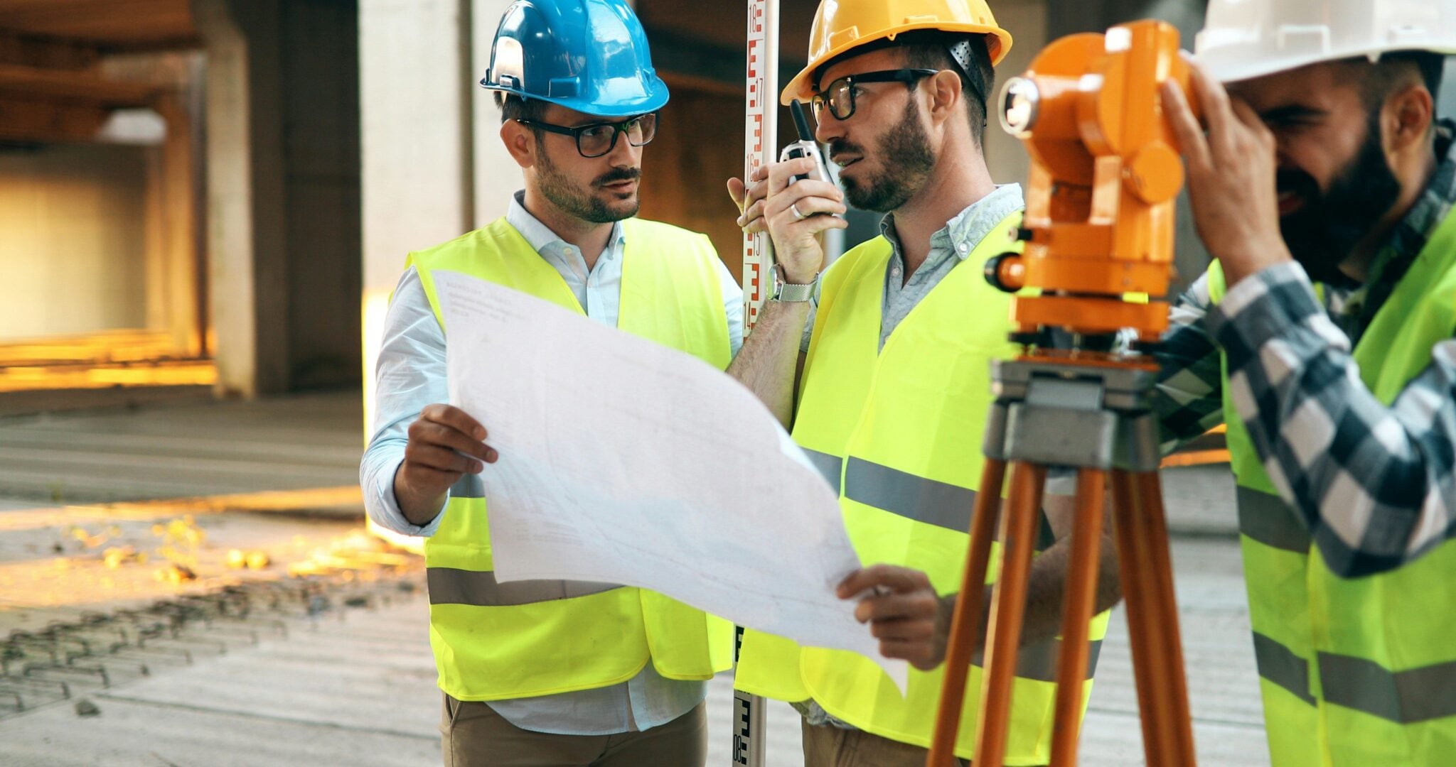 Project consultant talking to two builders