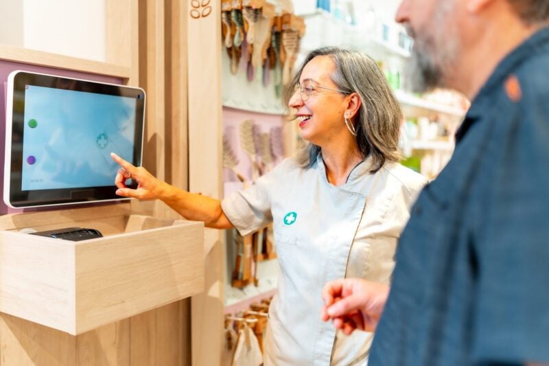 Woman in shop using smart screen